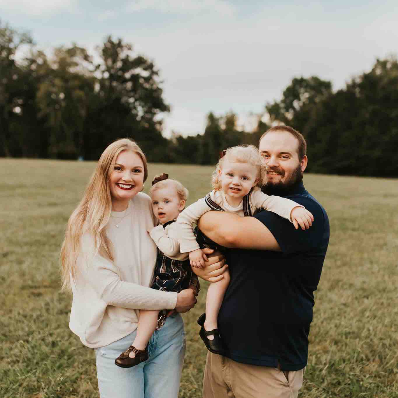 Billy Raulston with his wife and two children in a Tennessee field