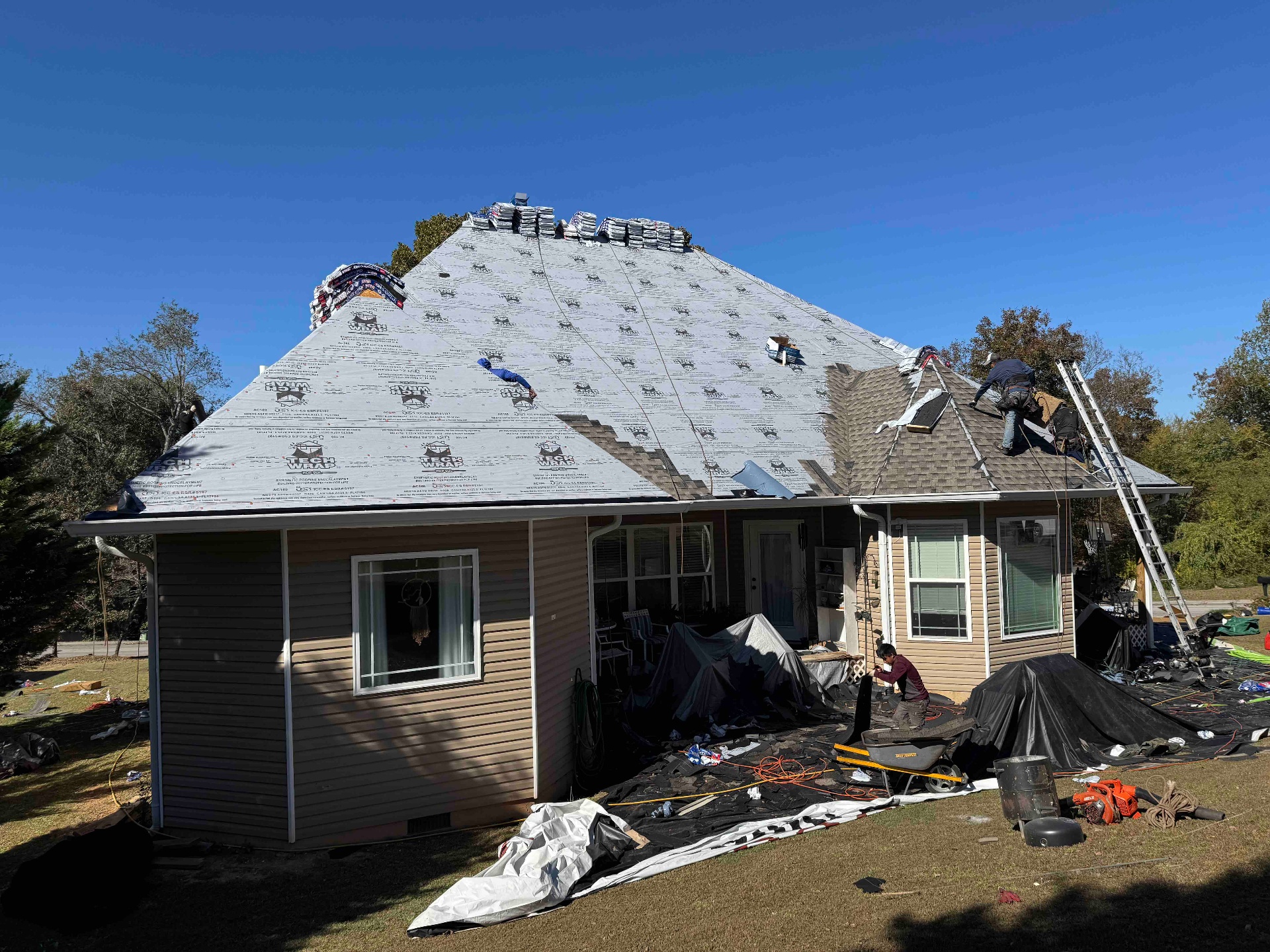 Tan Hip-Roof Home, TechWrap Underlayment with Shingles Staged